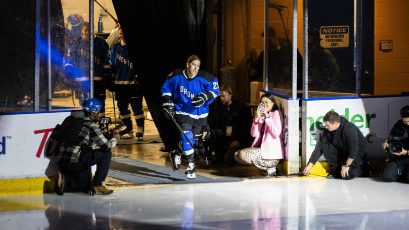Toronto PWHL player Emma Keenan skates onto the ice in pre-game player introductions