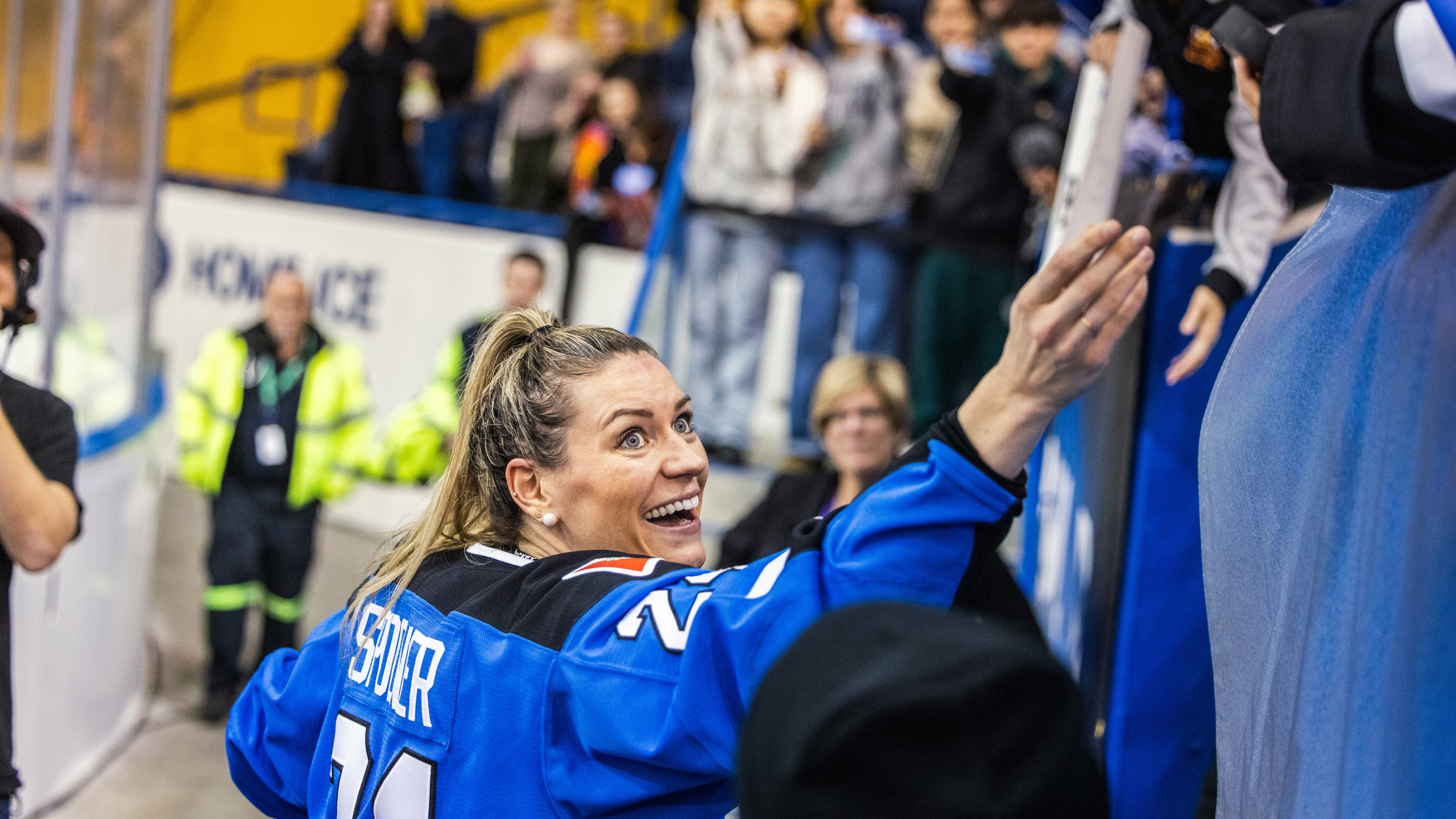 PWHL Toronto player Natalie Spooner high fives fans