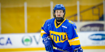 TMU women's hockey player Emily Baxter stands on the ice