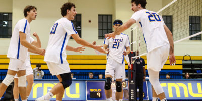 Players from the TMU men's volleyball team celebrate after scoring a point