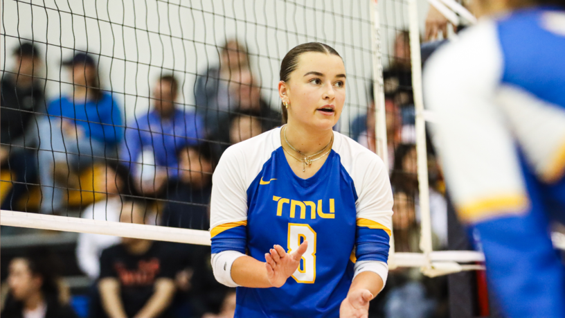 TMU Bold women's volleyball player Sarah Zonneveld claps on her teammates on court