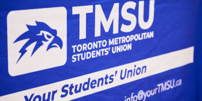 A blue banner displaying the TMSU logo. Underneath the logo is a line of text stating "Your Students' Union" and the TMSU's contact information.