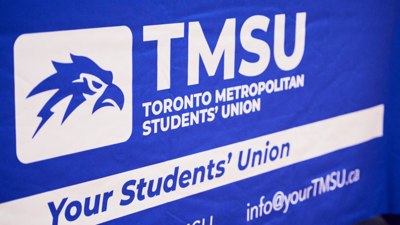 A blue banner displaying the TMSU logo. Underneath the logo is a line of text stating "Your Students' Union" and the TMSU's contact information.