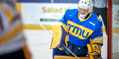 A TMU Bold women's hockey goalie looks dejected in the net