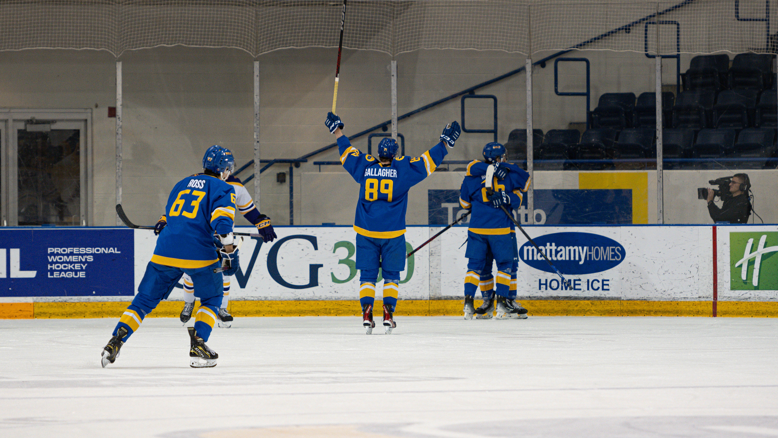 Members of the TMU Bold men's hockey team celebrate on the ice
