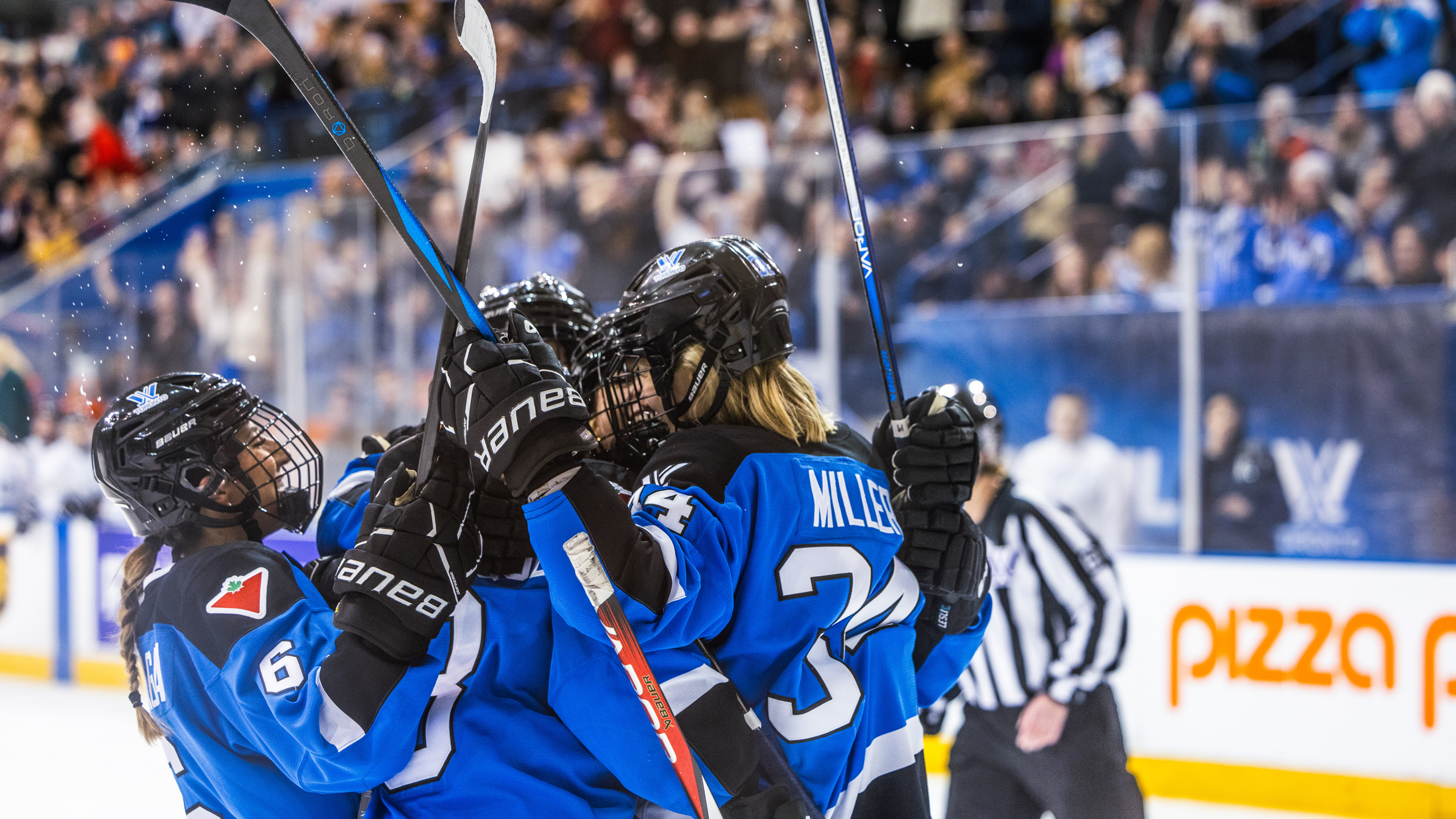 Players from PWHL Toronto celebrate a goal