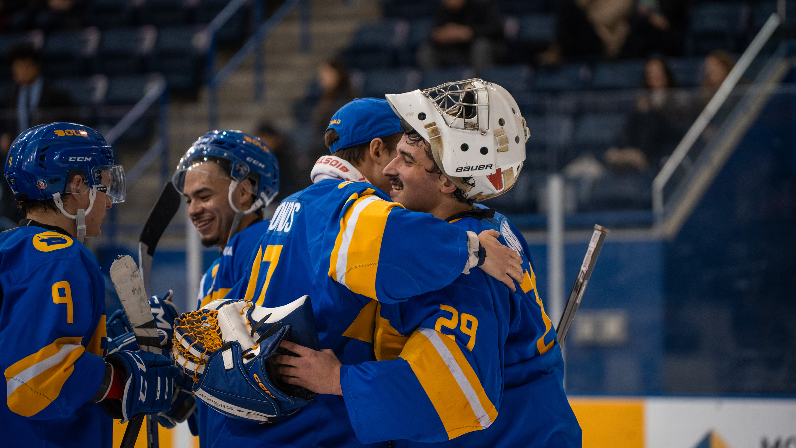 TMU men's hockey goaltenders Kai Edmonds and Ryan Dugas hug each other