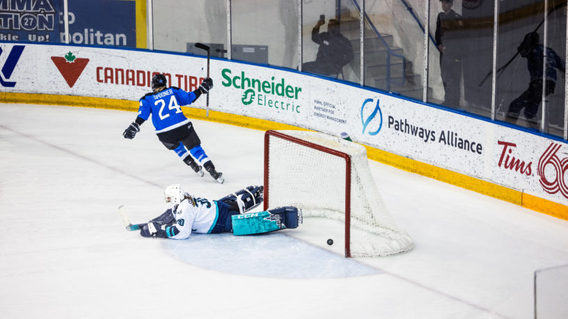 PWHL Toronto player Natalie Spooner raises her stick in the air after scoring a shootout goal