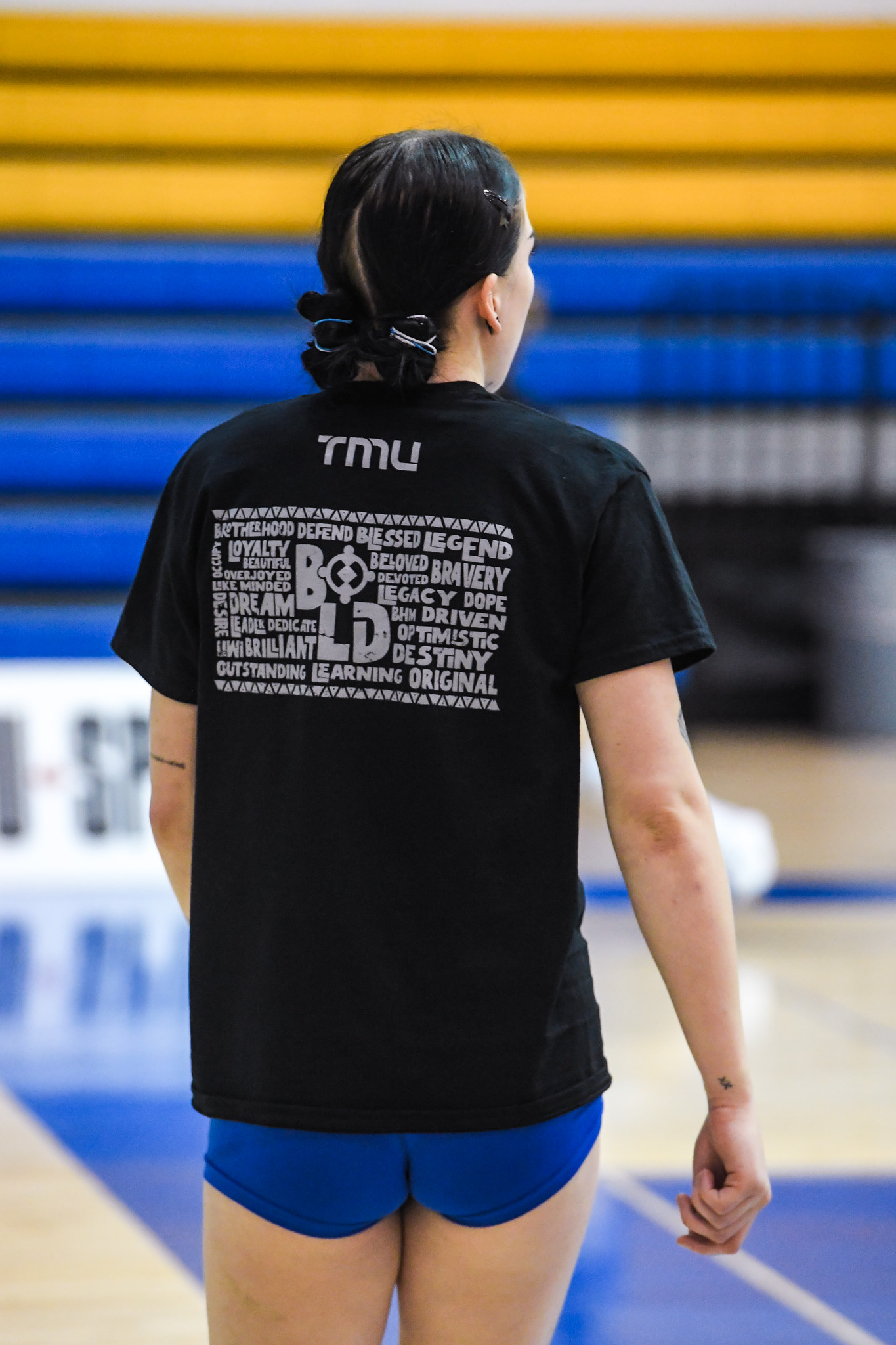 TMU women's volleyball player Adyson Wilson warmups while wearing the Black History Month-designed shirt