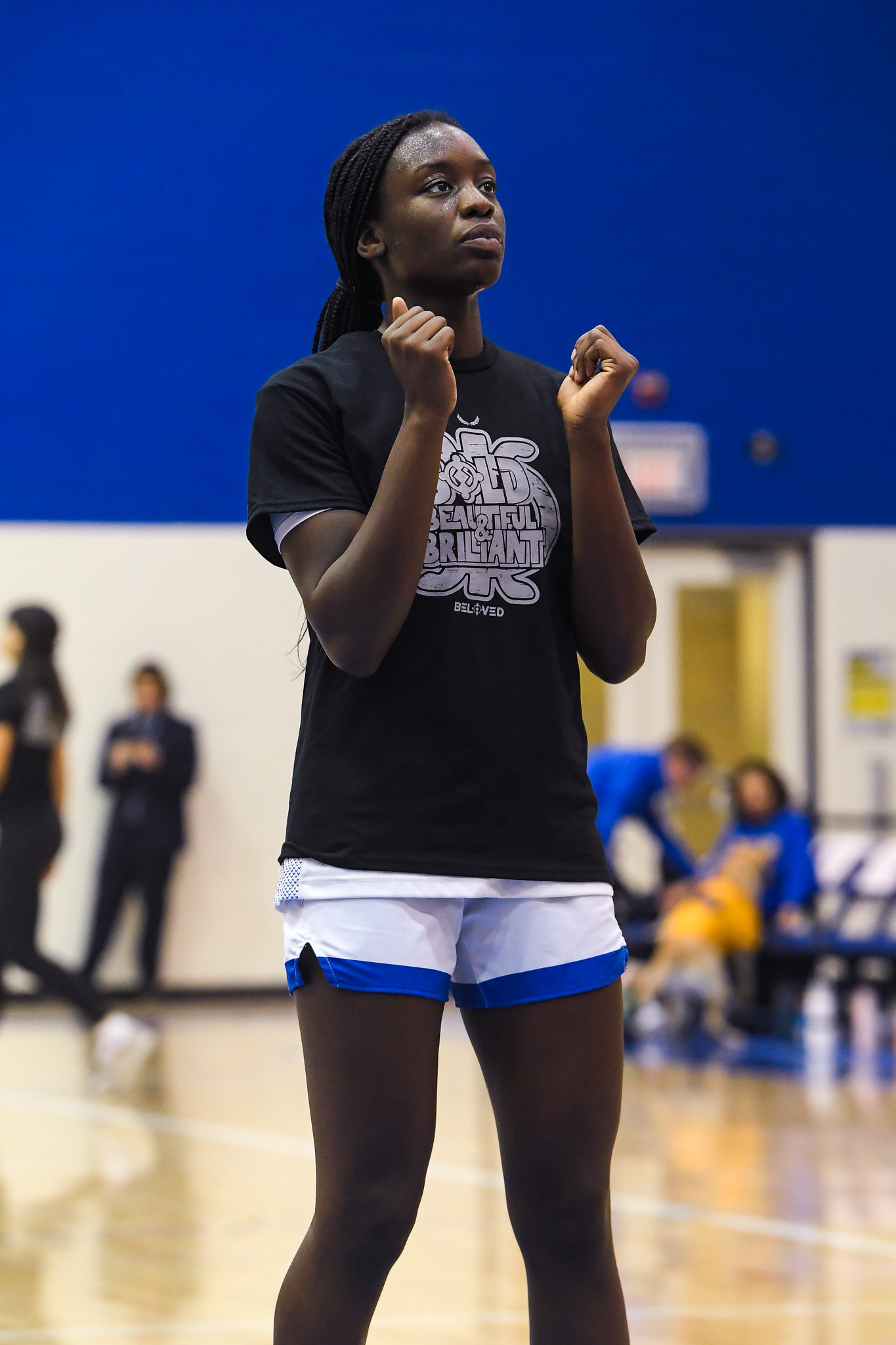 TMU women's basketball player Jess Keripe warmups while Black History Month-designed shirt