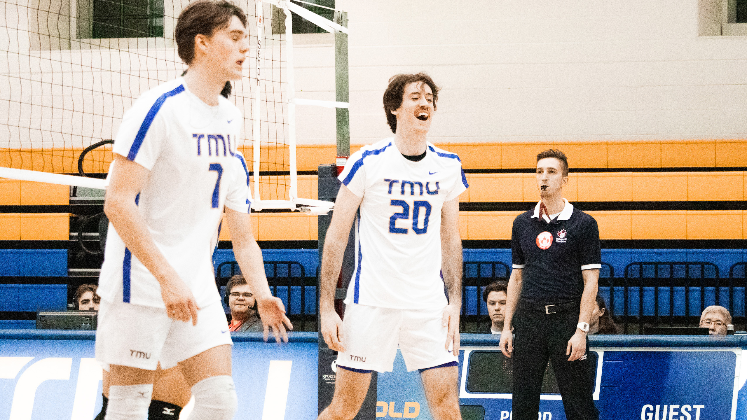 TMU men's volleyball player Alex King yells in celebration alongside Ben Davey on the court