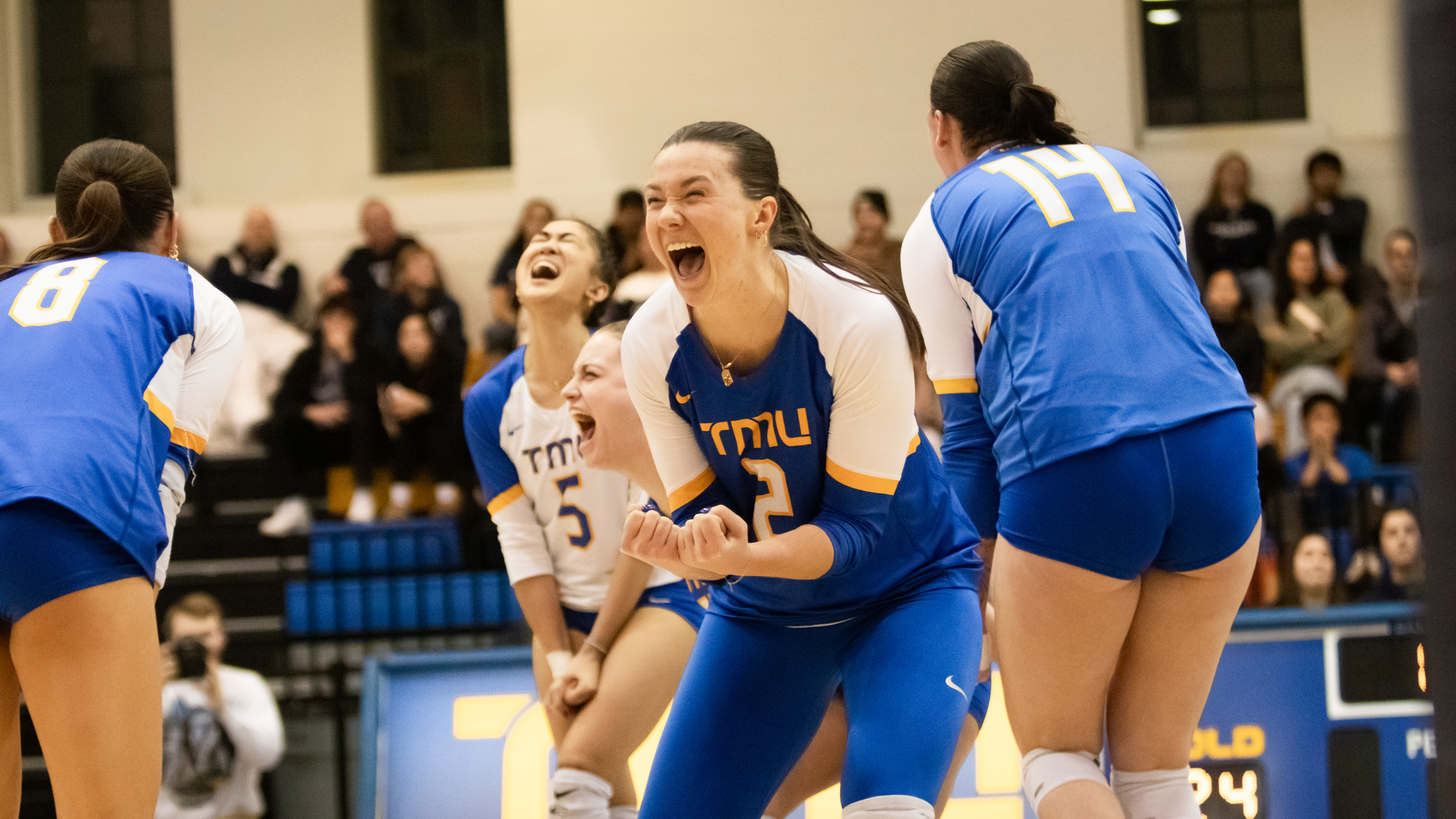 TMU Bold women's volleyball player Julie Gordon screams in excitement