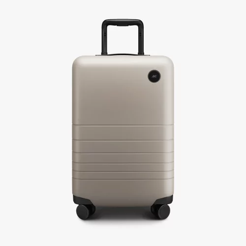 Grey hard-shell suitcase with extended handle.
