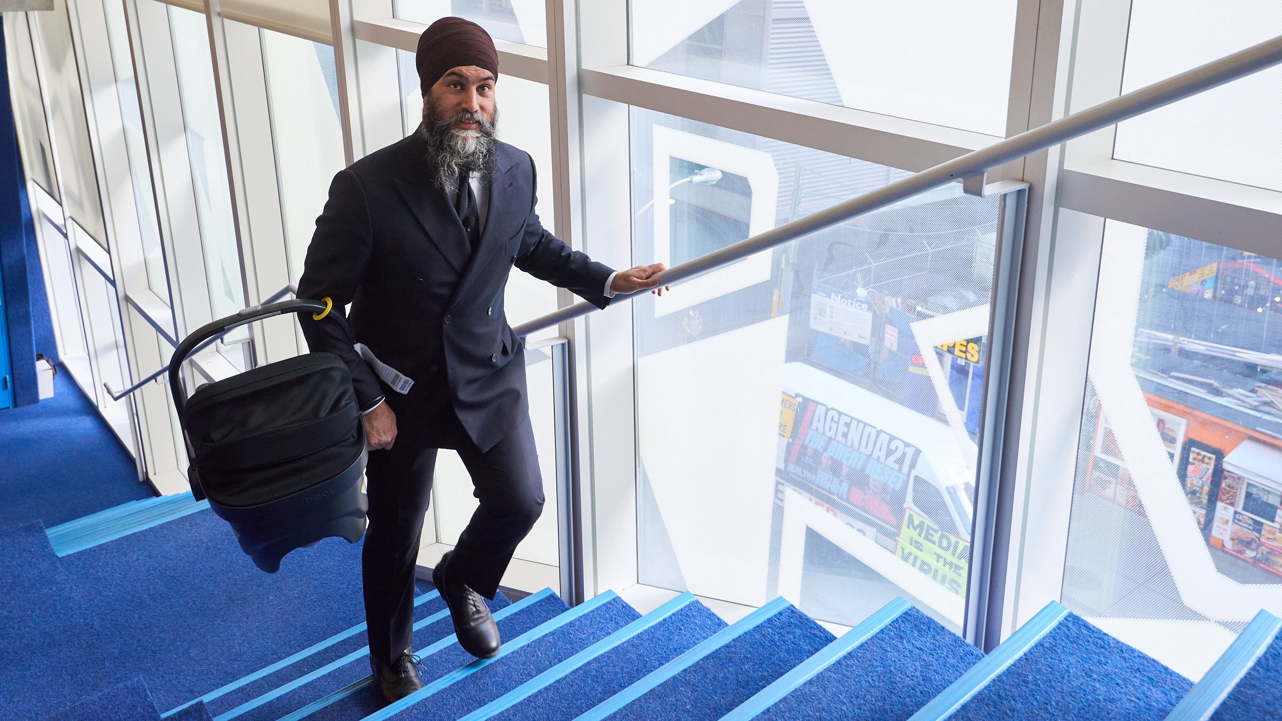 Jagmeet Singh walks up stairs with his child