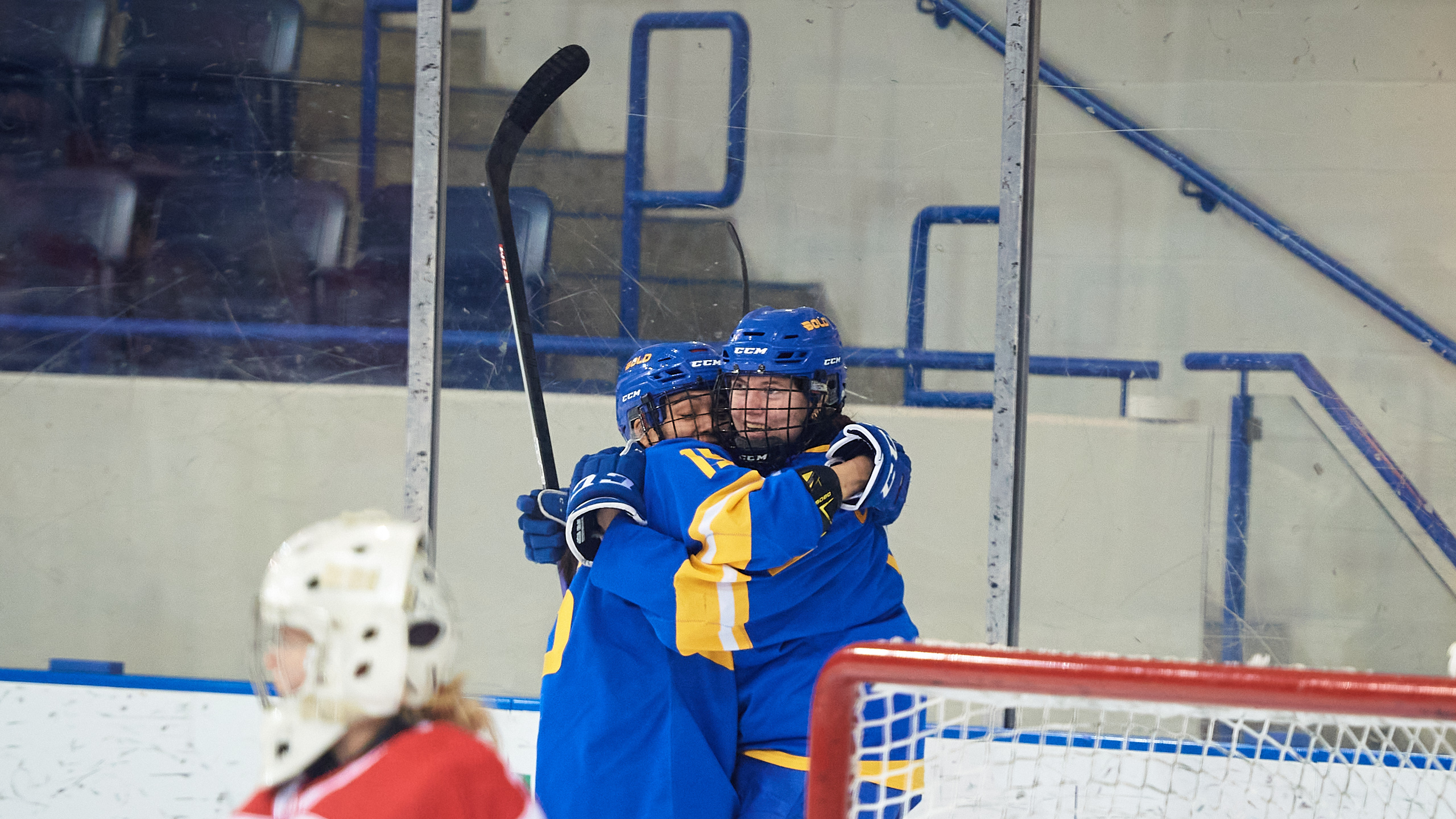 TMU women's hockey players Gaby Gareau and Kayla Kondo hug after a goal