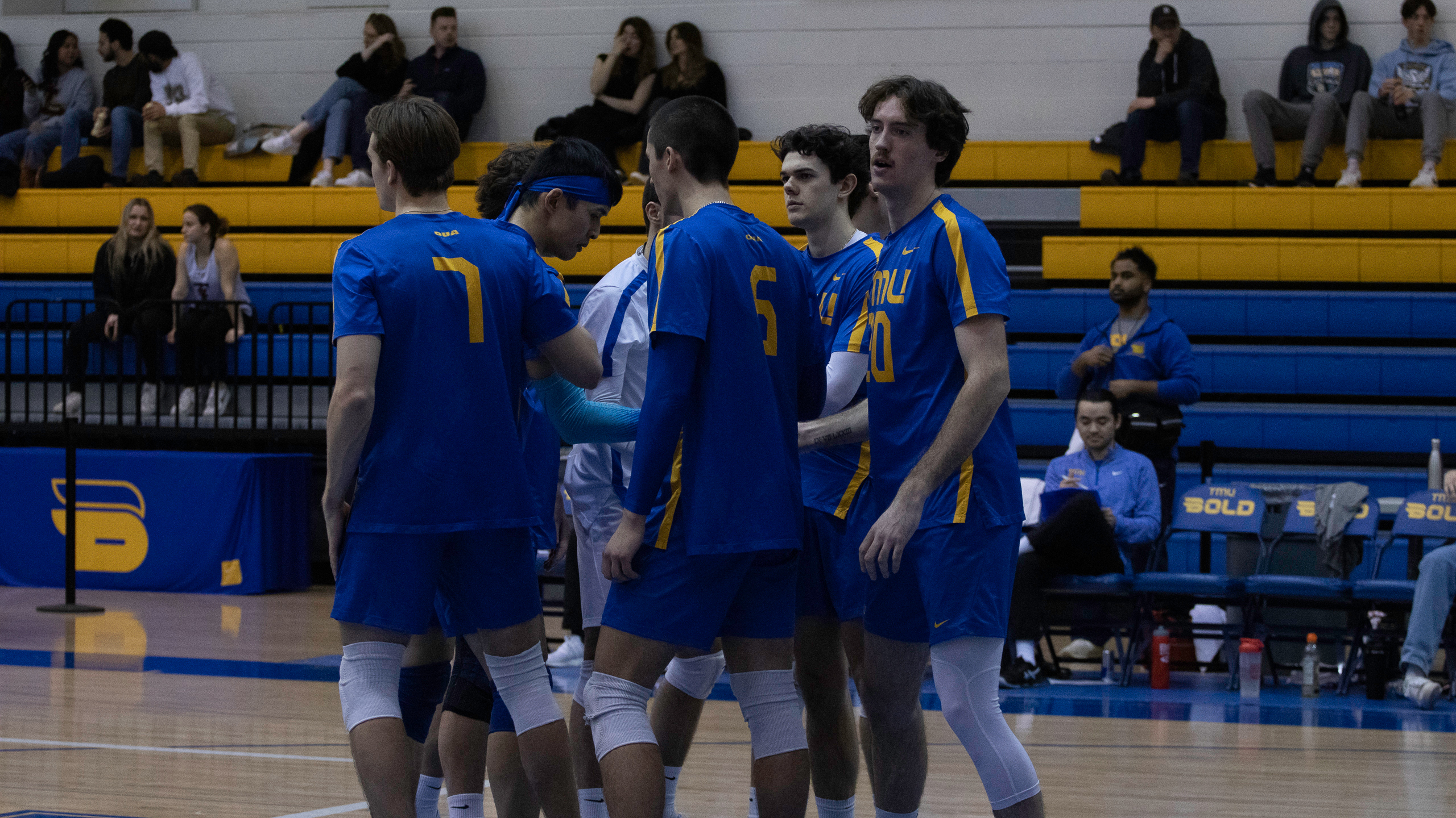 Members of the Bold men's volleyball team huddle together