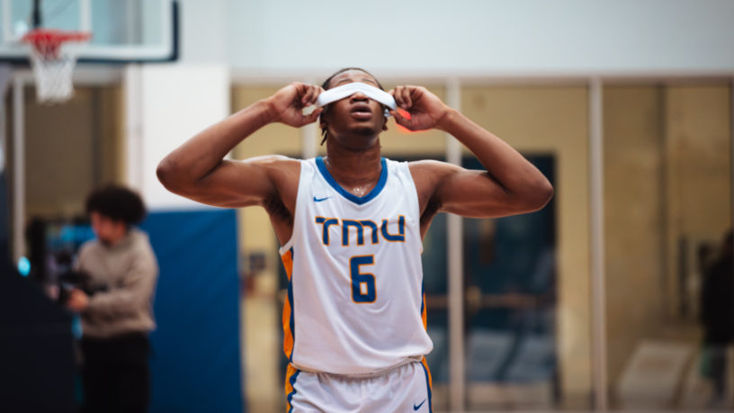 TMU Bold men's basketball player David Walker pulls his sweatband over his eyes after losing in the playoffs