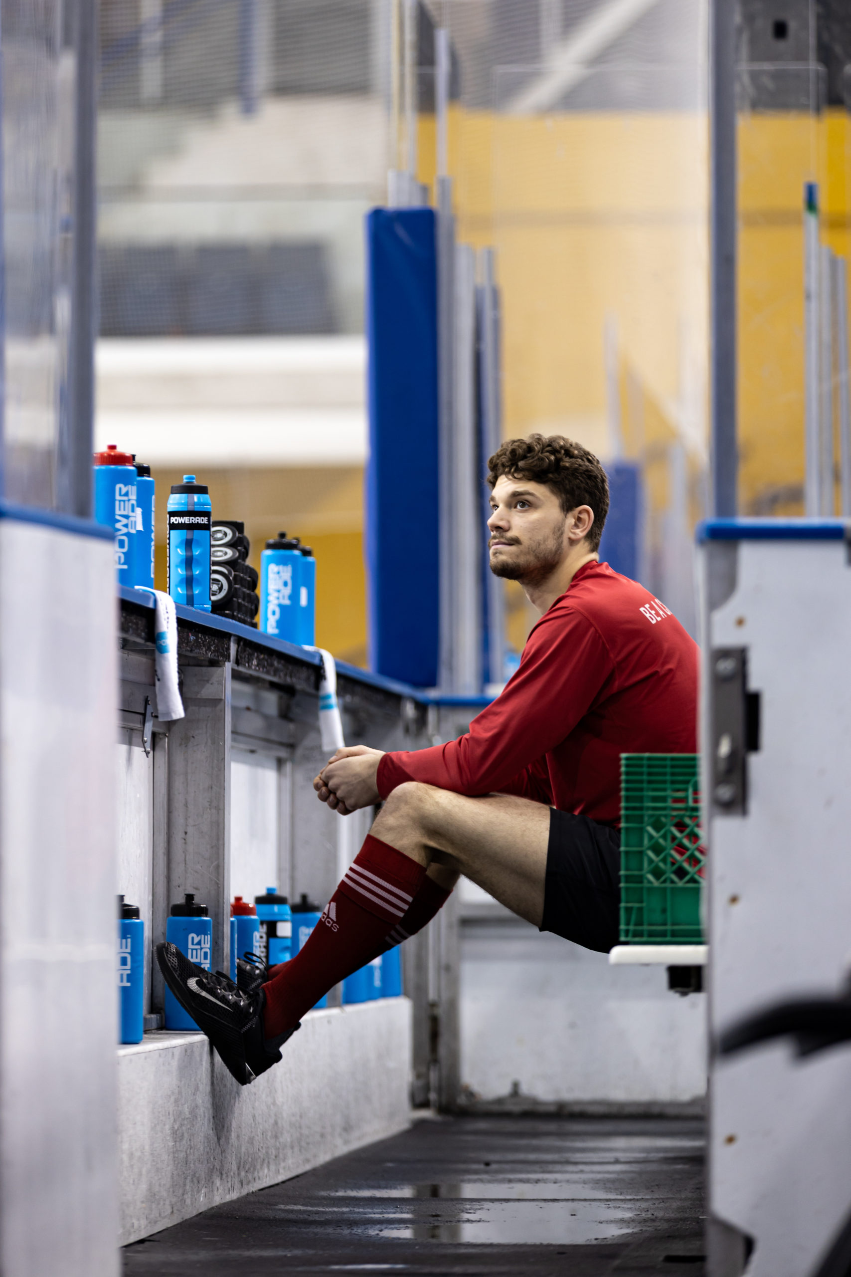 A McGill Redbirds player sits on his team bench before the game begins