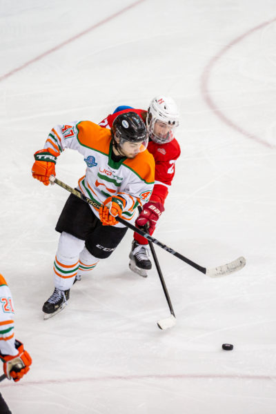 A McGill player chases a UQTR player with the puck
