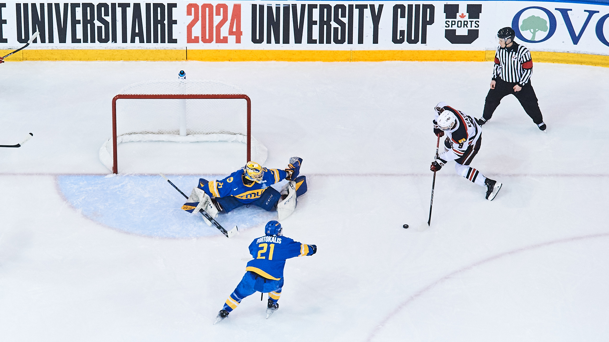 A UNB player shoots the puck into the TMU net