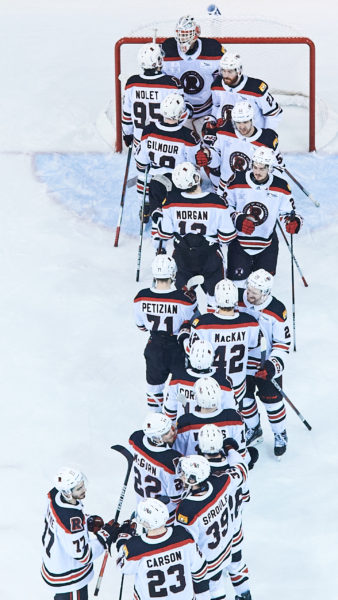 UNB players line up in a group near their net after winning
