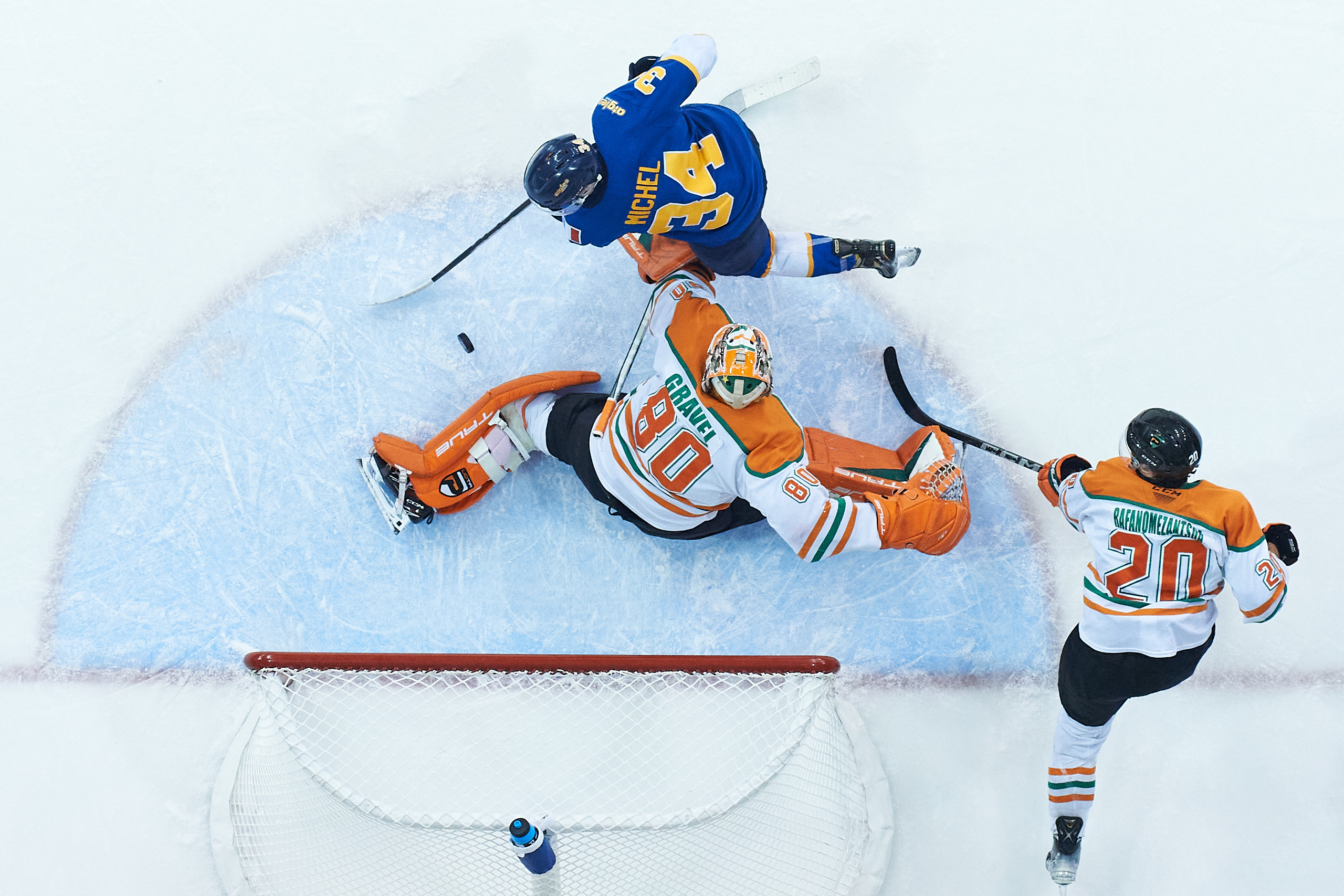 An overhead shot of UQTR goaltender stopping a close from a Moncton player