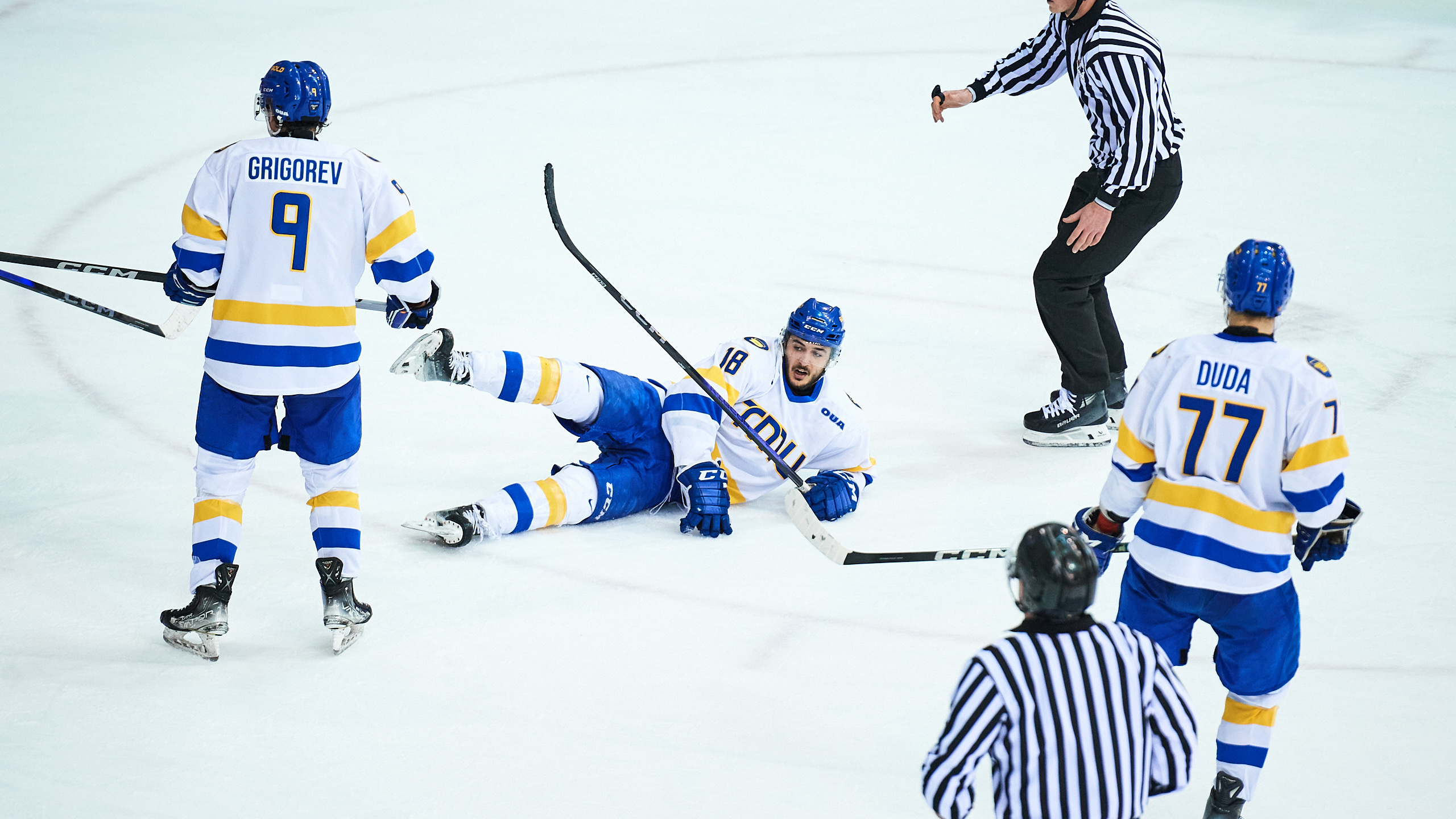 A TMU player lays on the ice after contact