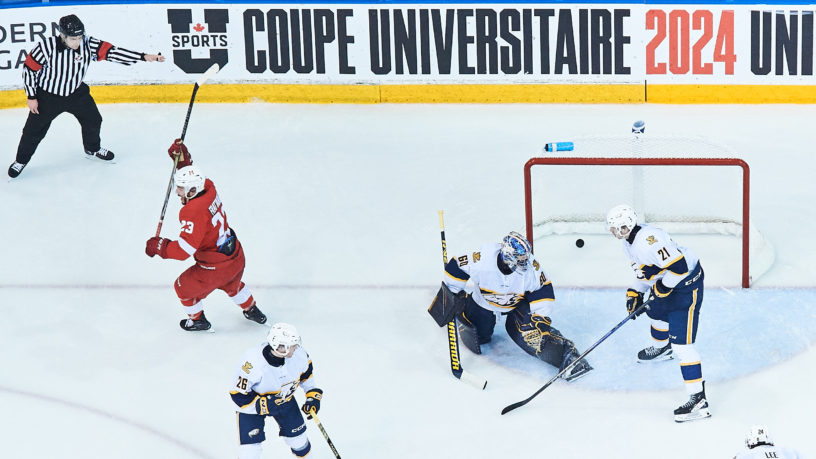 A McGill University hockey player celebrates after scoring against UBC