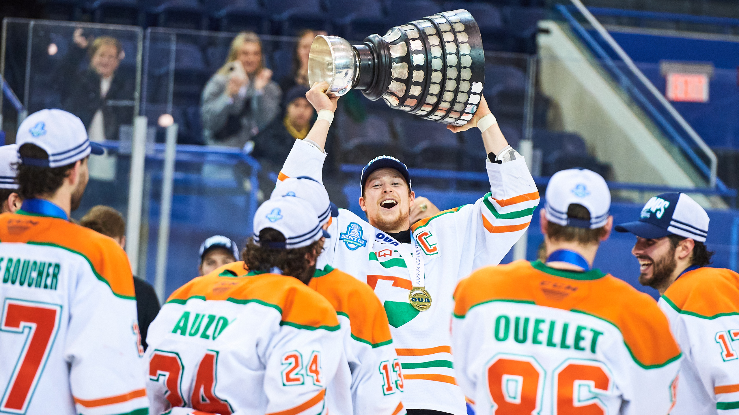 UQTR captain lifts the Queen's Cup and smiles