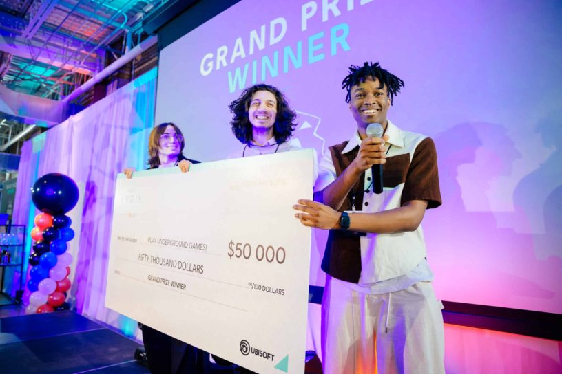 Three people hold cheque for $50,000