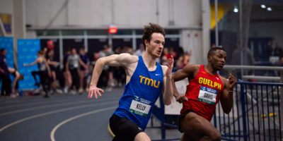 TMU track athlete Aaron Kelly races against Guelph athlete Richard Davis