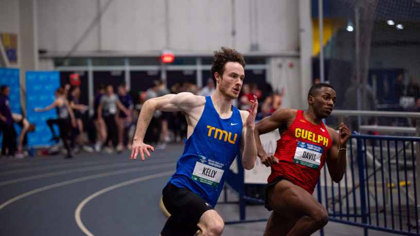 TMU track athlete Aaron Kelly races against Guelph athlete Richard Davis