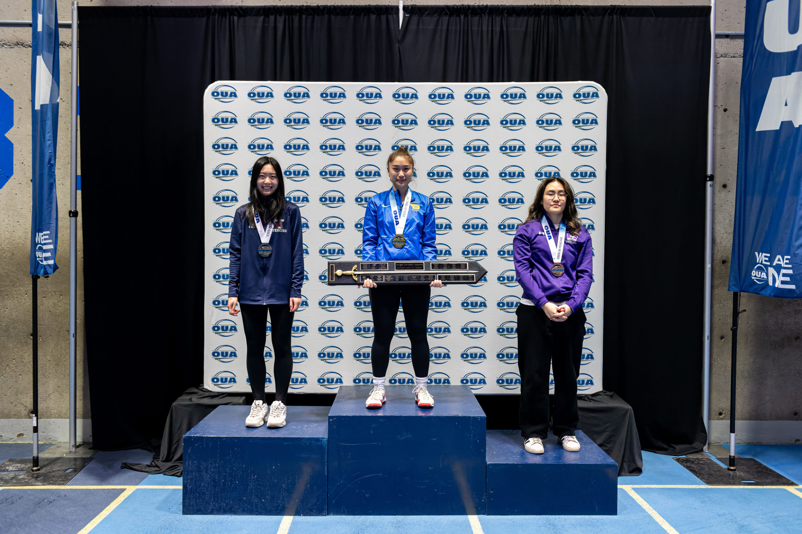 Erika Dominguez stands atop the OUA podium as the champion
