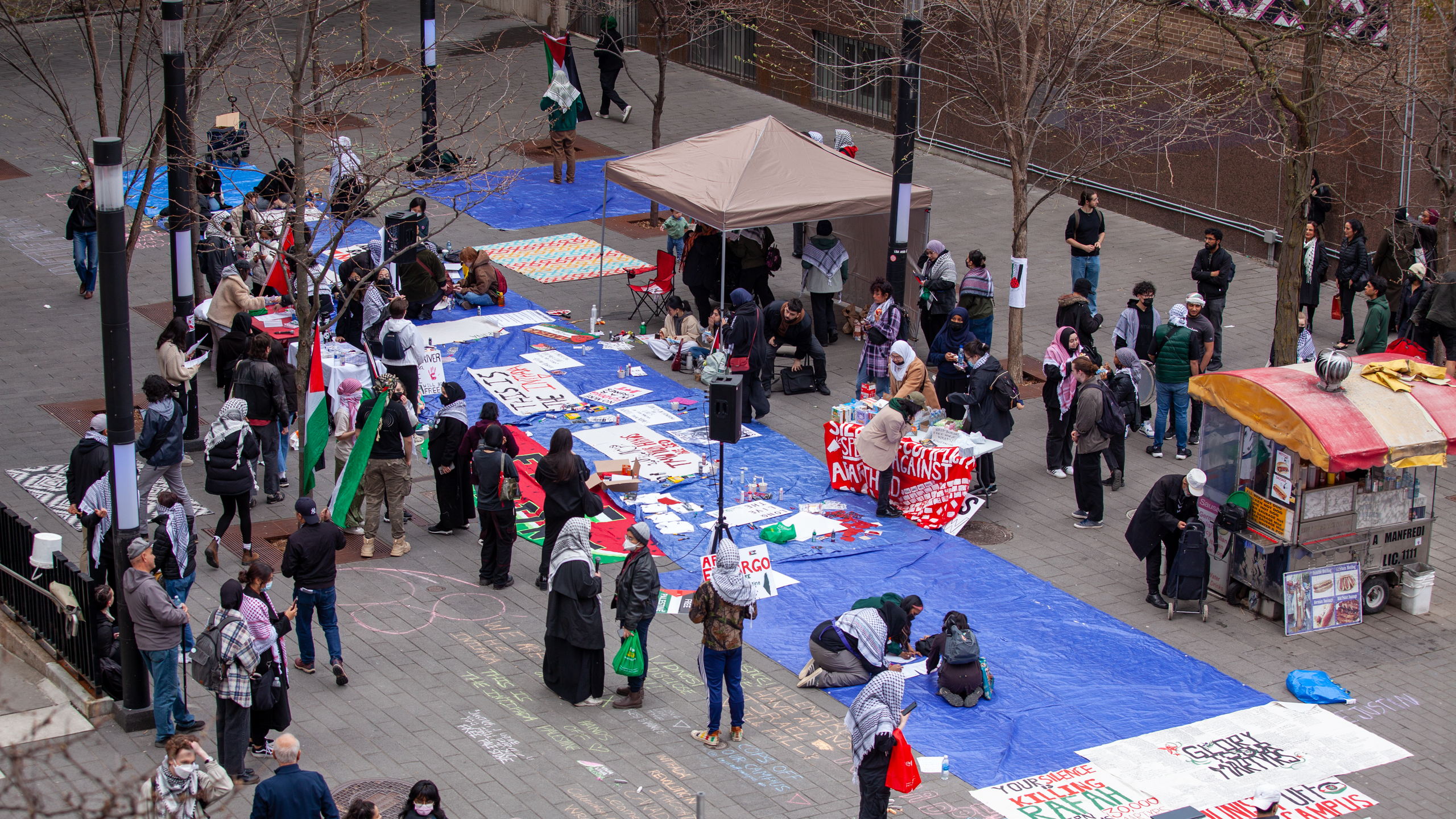 An overhead shot of the sit-in held at Victoria and Gould Streets on April 30 where students are seen drawing slogans on posters.