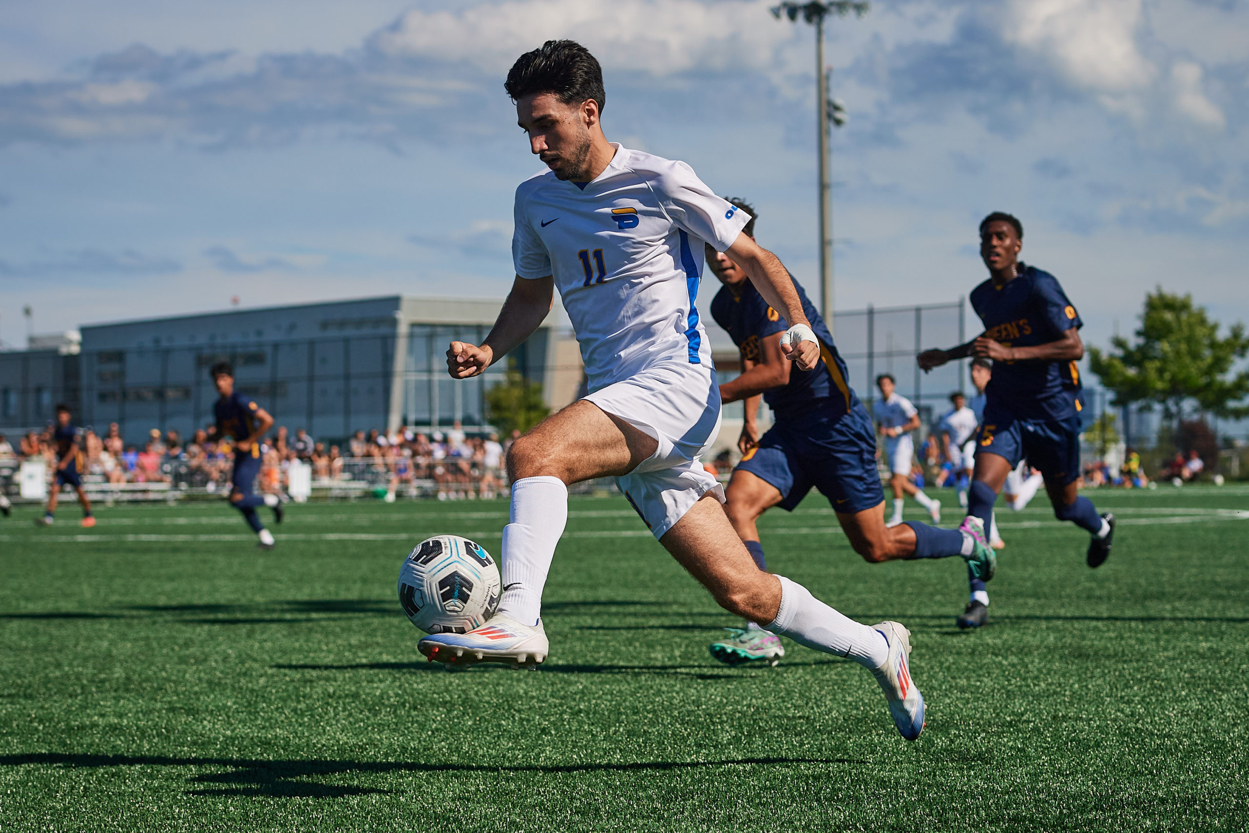 TMU Bold men's player Justin Santos handles a soccer ball with his foot. It rests on op of his foot and against his ankle