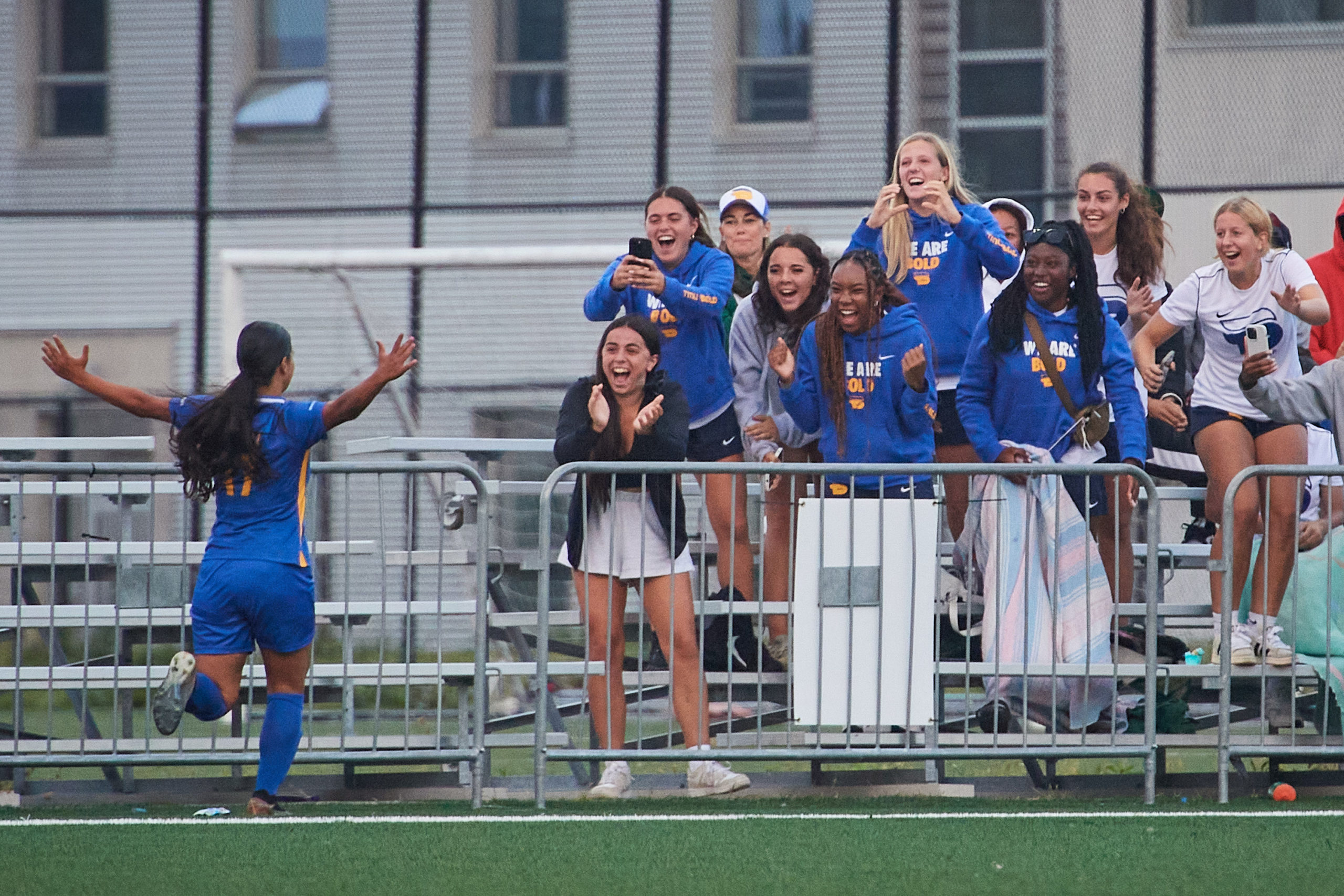 first-year midfielder Mera Saleh celebrating, with other players of the team in the bleechers, her first goal with the TMU Bold