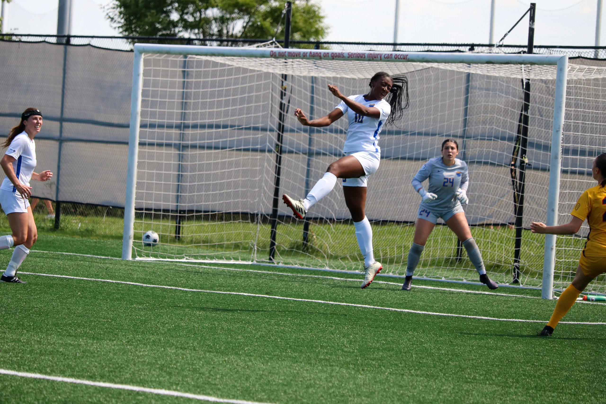 TMU Bold women's soccer player Tierra Bennett remains in the air after hitting a ball with her head in front of her own goalkeeper.