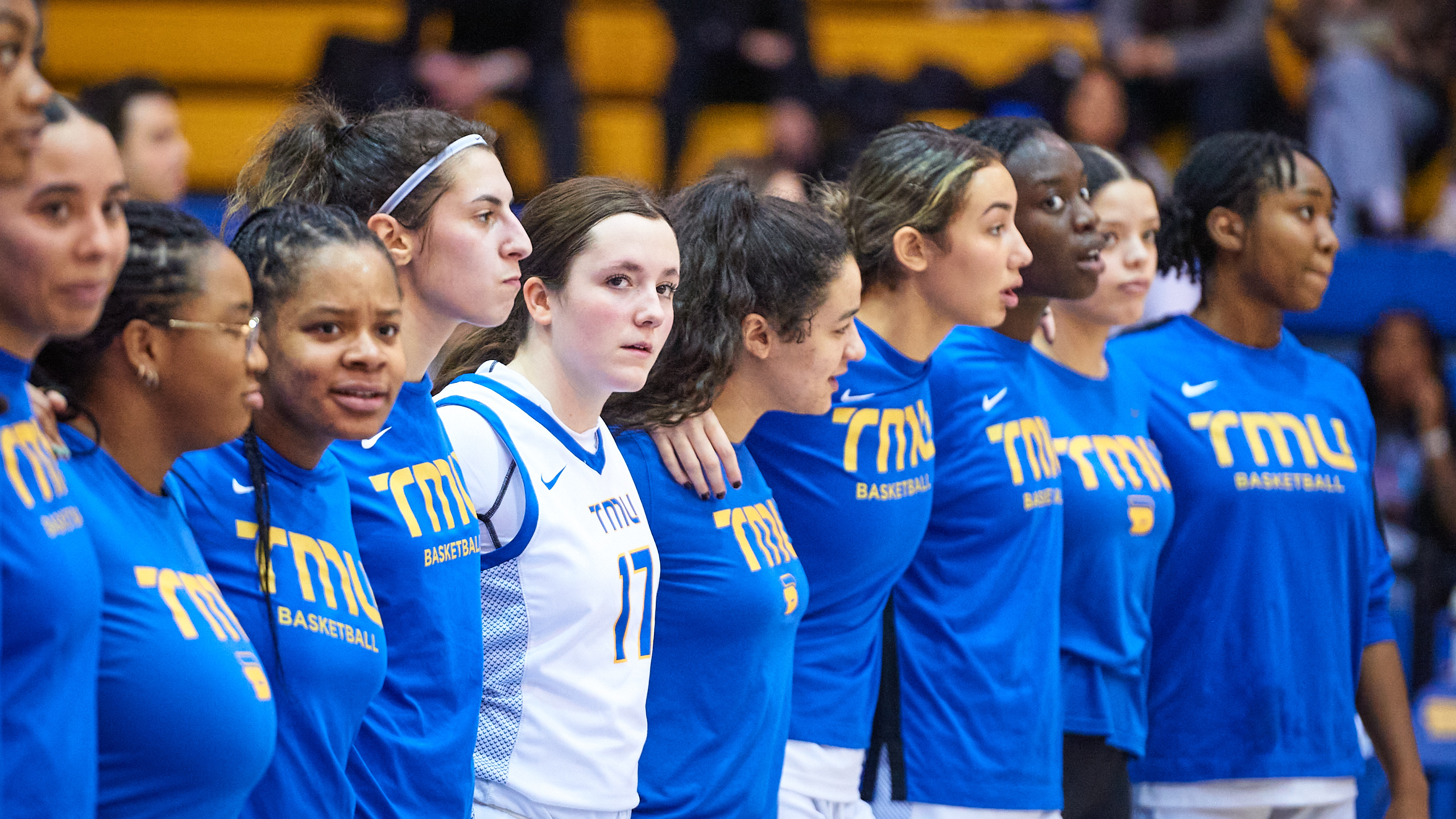 A female sports team stands in a line