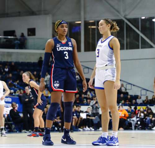 TMU Bold women's basketball player Hailey Franco-DeRyck stands beside UConn player Aalayah Edwards near the free throw line at the MAC.