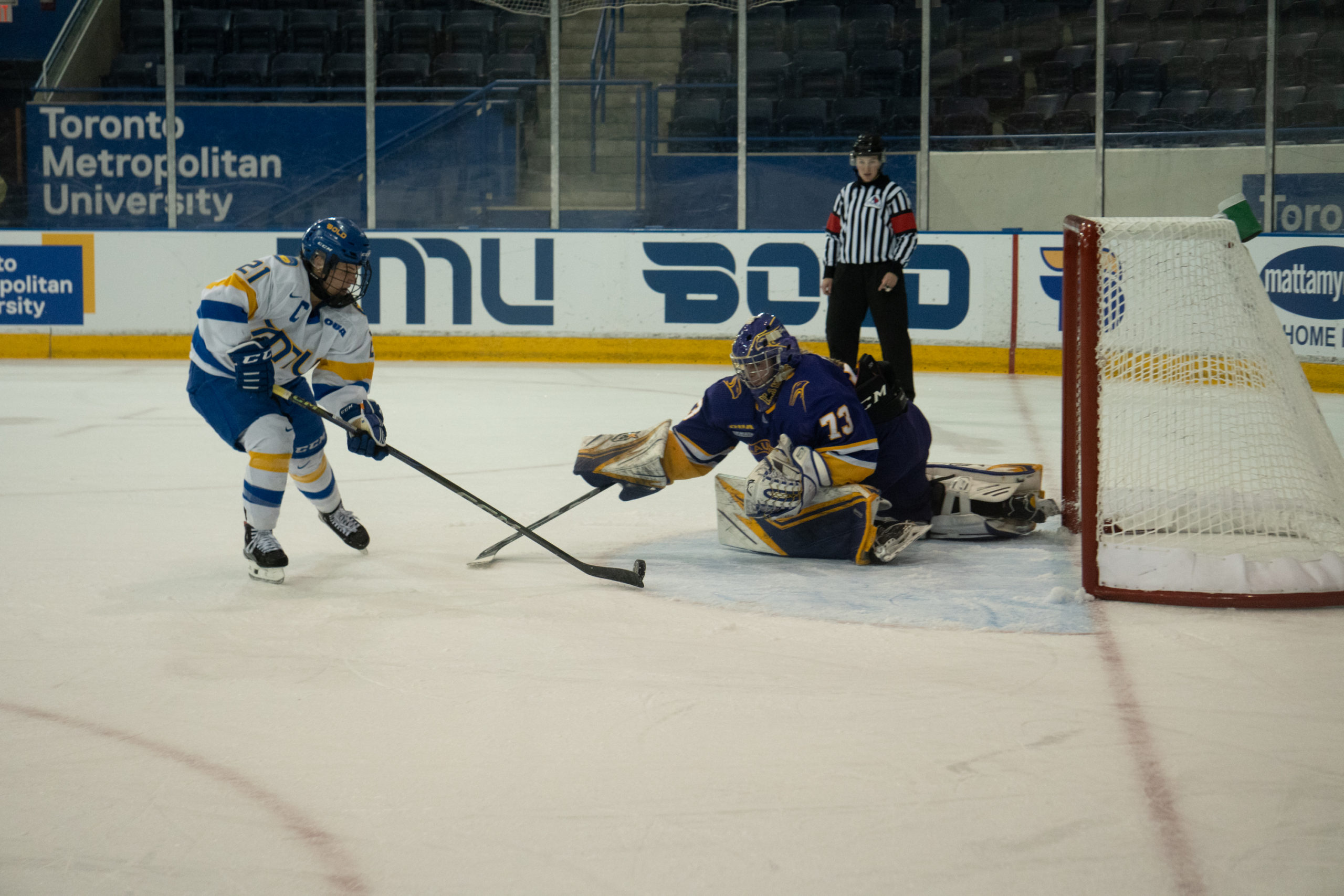 Emily Baxter dekes past the poke-check of Laurier goaltender Kayla Renaud before scoring in the shootout