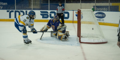 TMU Bold women's hockey player Emily Baxter backhands a shot past Laurier goaltender Kayla Renaud in the shootout