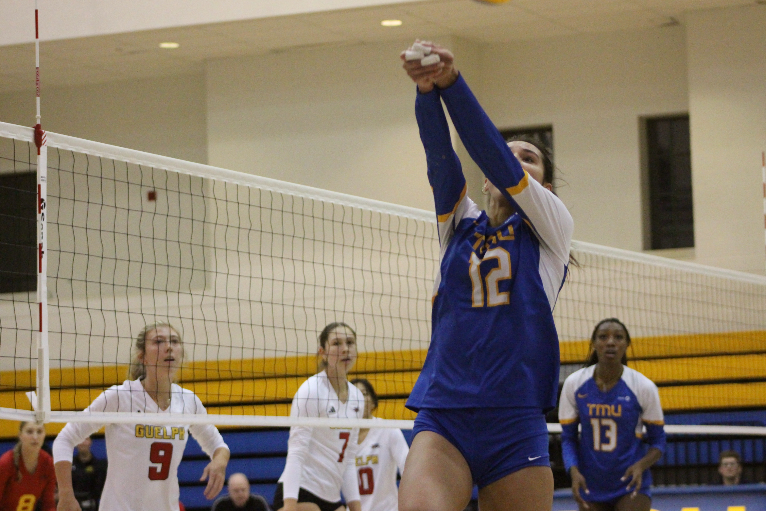 Scarlett Gingera bumps a volleyball over her own head