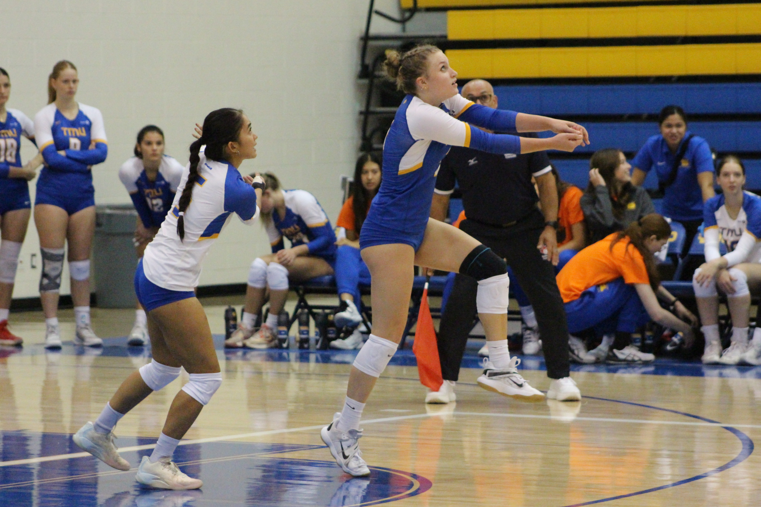 Kaiya Krahn bumps a volleyball with Mary Rioflorido ready to bump behind her