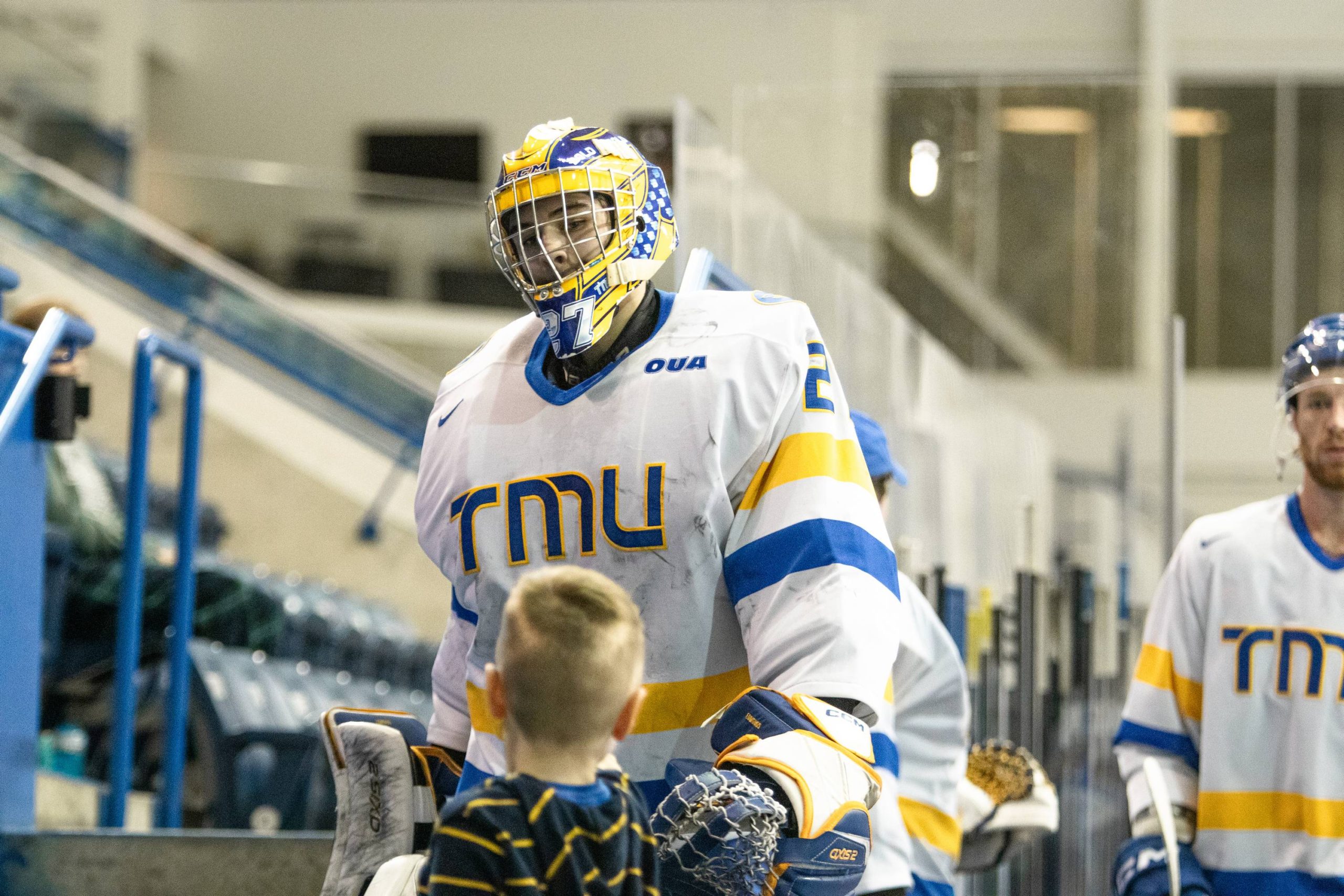 Kai Edmonds bumping his fist with a little fan 