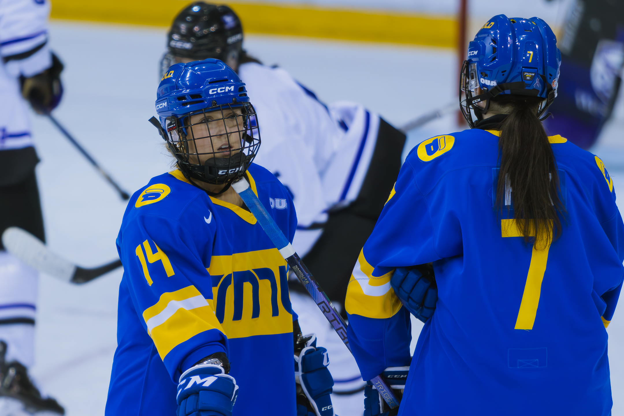 Jayden Fox and Megan Bergmanis talking in the middle of the game 