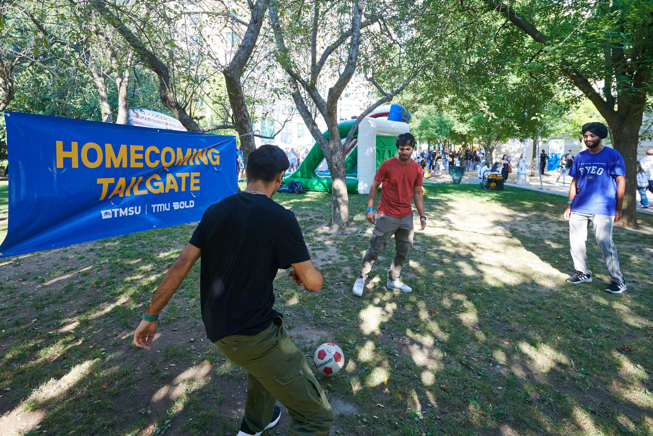 a couple of students playing soccer at the tailgate event at Pitman Hall Quad