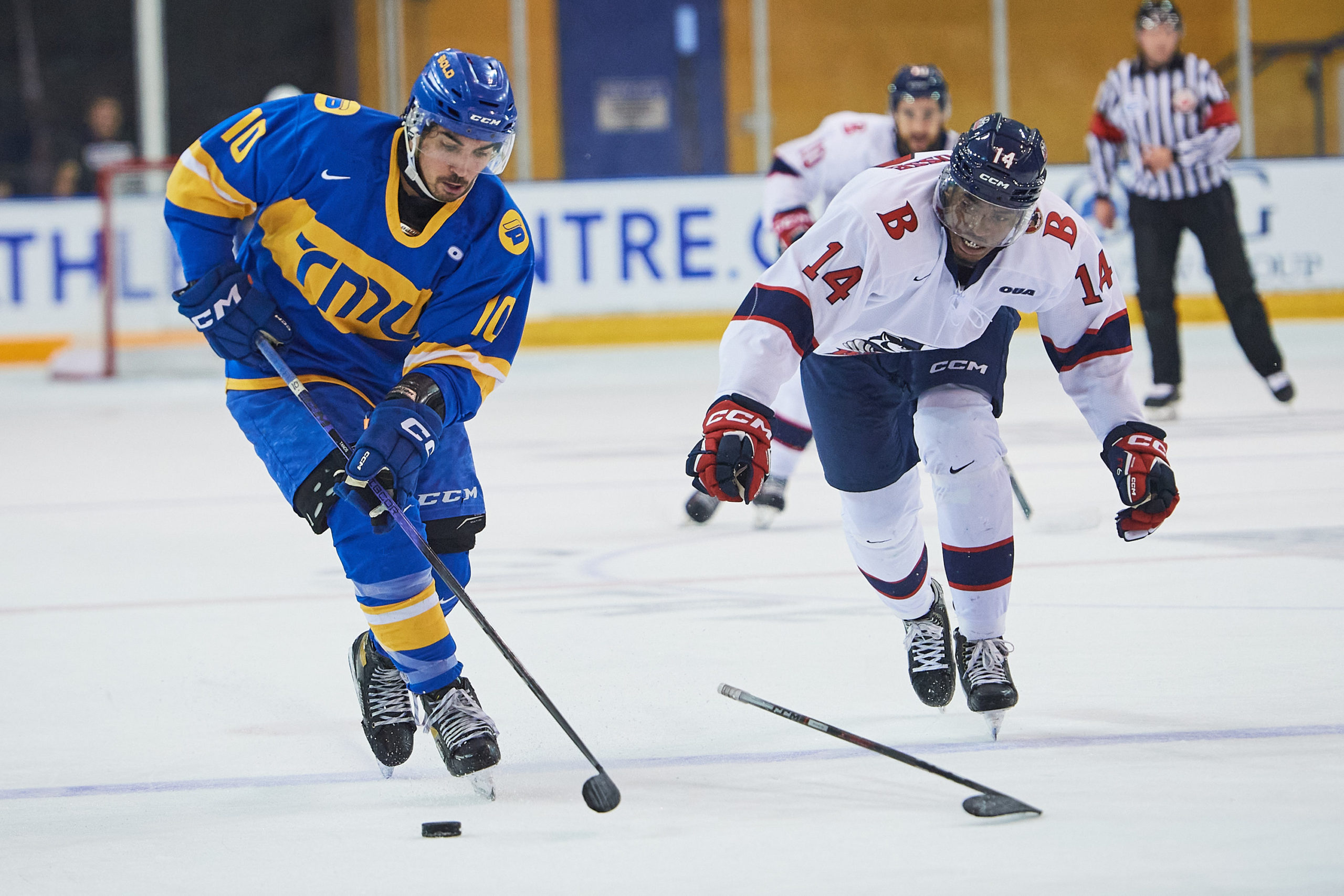 Evan Tanos dangling with the puck next to a Brock player