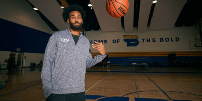 Moustapha Youssouf tosses a basketball on the court at the MAC