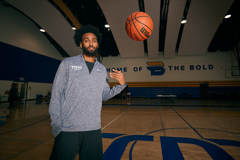 Moustapha Youssouf tosses a basketball on the court at the MAC