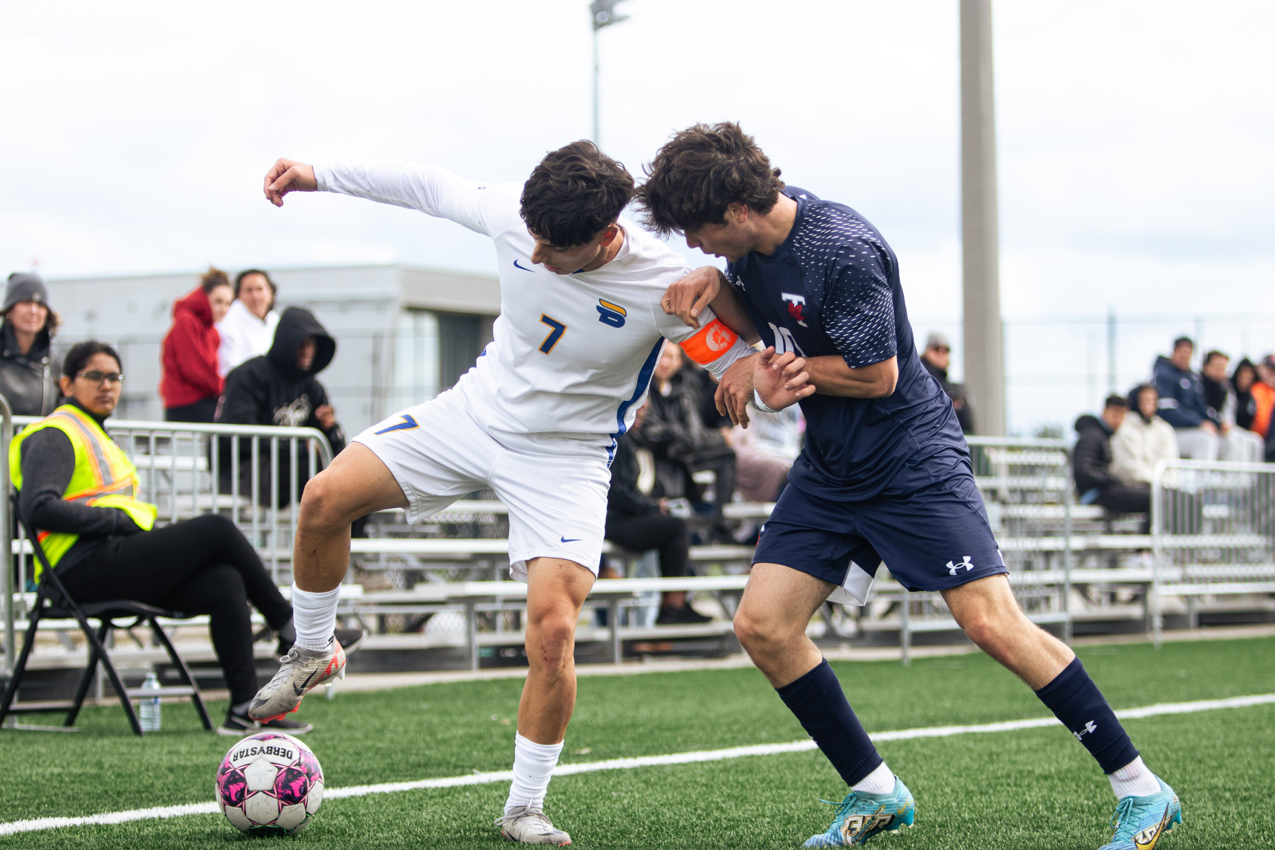 Attacker Luca Di Marco defending the ball against U of T from the corner flag 